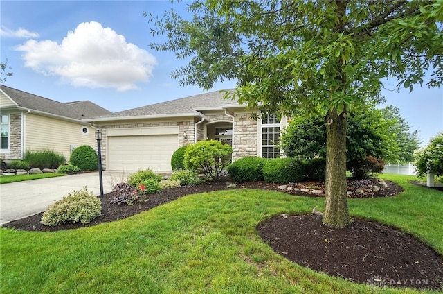 10101 Sawtry Ln, Washington Twp, OH 45458 - view of front of home with stone siding, an attached garage, driveway, and a front lawn