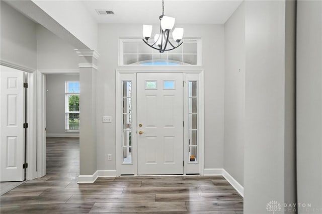 10101 Sawtry Ln, Washington Twp, OH 45458 - foyer entrance featuring a chandelier, wood finished floors, and ornate columns