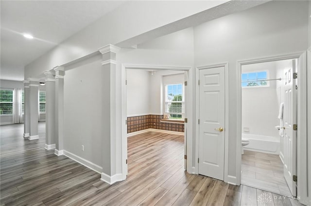 10101 Sawtry Ln, Washington Twp, OH 45458 - hall featuring wood finished floors, decorative columns, and healthy amount of natural light