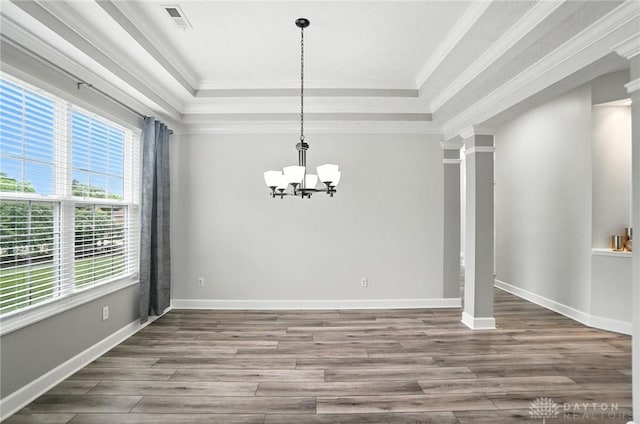 10101 Sawtry Ln, Washington Twp, OH 45458 - unfurnished dining area featuring wood finished floors, a chandelier, a raised ceiling, ornamental molding, and ornate columns
