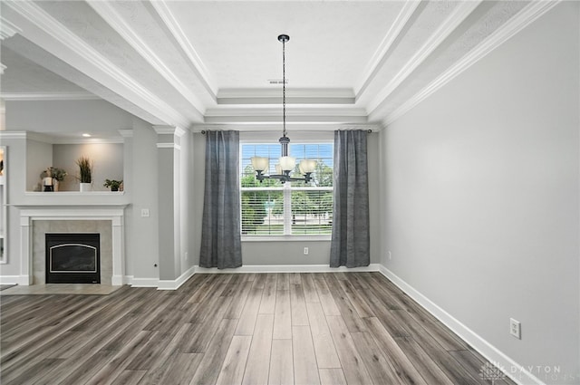 10101 Sawtry Ln, Washington Twp, OH 45458 - unfurnished dining area with a chandelier, wood finished floors, a tiled fireplace, a tray ceiling, and crown molding