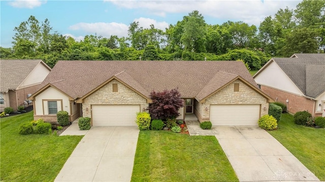 797 Waldsmith Way, Vandalia, OH 45377 - view of front of property featuring stone siding, an attached garage, and concrete driveway