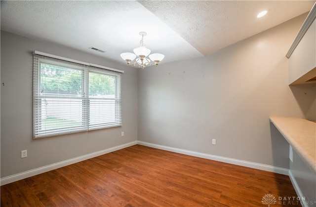 797 Waldsmith Way, Vandalia, OH 45377 - empty room featuring a chandelier, wood finished floors, and a textured ceiling
