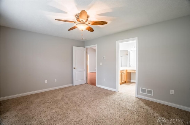 797 Waldsmith Way, Vandalia, OH 45377 - unfurnished bedroom featuring light carpet, ensuite bathroom, and ceiling fan