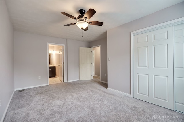 5587 Penn Ave, Riverside, OH 45432 - unfurnished bedroom with light carpet, a closet, connected bathroom, and a ceiling fan