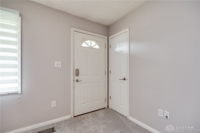 5587 Penn Ave, Riverside, OH 45432 - entryway featuring light colored carpet and a textured ceiling