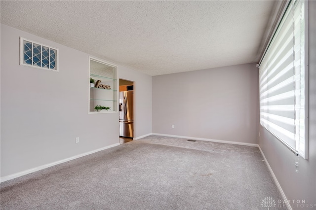 5587 Penn Ave, Riverside, OH 45432 - empty room featuring carpet and a textured ceiling