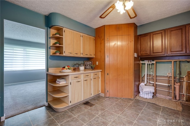 5587 Penn Ave, Riverside, OH 45432 - kitchen with open shelves, ceiling fan, a textured ceiling, carpet flooring, and light countertops