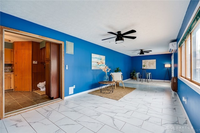 5587 Penn Ave, Riverside, OH 45432 - living area featuring marble look tile flooring, a ceiling fan, a wall unit AC, healthy amount of natural light, and a textured ceiling