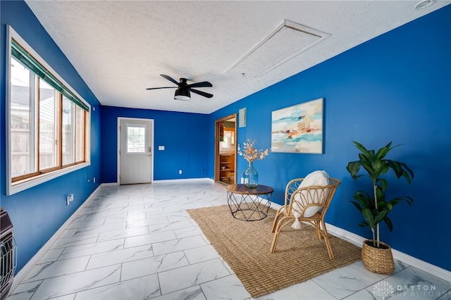 5587 Penn Ave, Riverside, OH 45432 - living area with marble look tile flooring, a textured ceiling, ceiling fan, and attic access