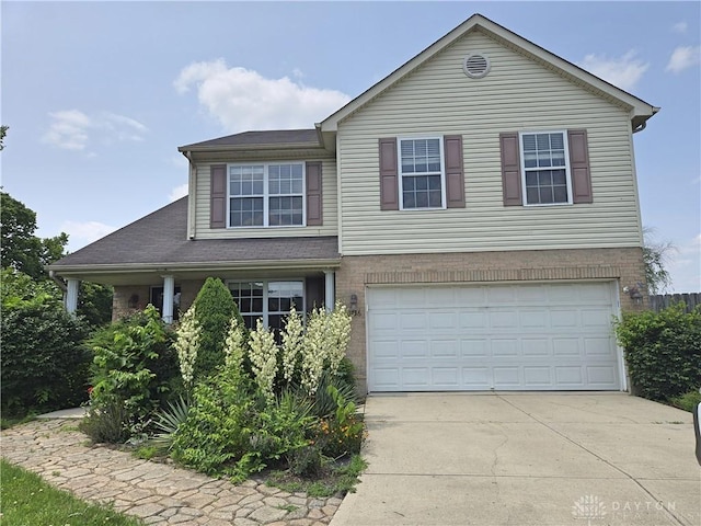 8736 Gingerwood Ct, Franklin, OH 45005 - view of front facade featuring an attached garage, driveway, and brick siding