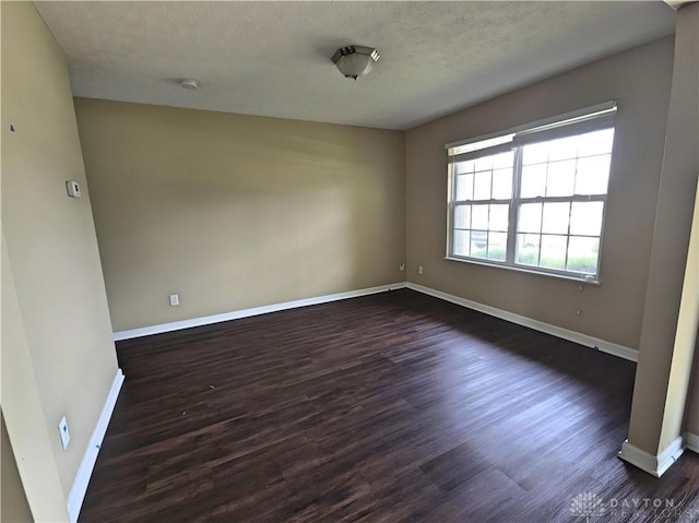 8736 Gingerwood Ct, Franklin, OH 45005 - unfurnished room featuring dark wood-type flooring and a textured ceiling