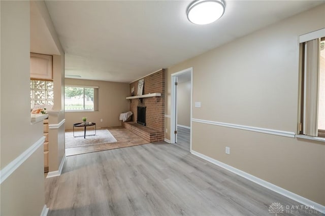 521 Park Ridge Dr, Centerville, OH 45459 - unfurnished living room featuring light wood-style flooring and a fireplace