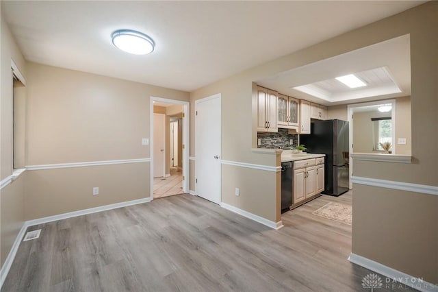 521 Park Ridge Dr, Centerville, OH 45459 - kitchen with freestanding refrigerator, light wood-style floors, dishwasher, light countertops, and backsplash
