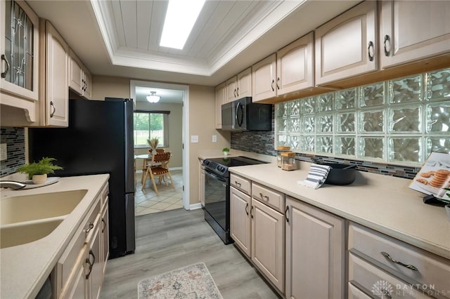 521 Park Ridge Dr, Centerville, OH 45459 - kitchen with black appliances, a tray ceiling, light wood finished floors, light countertops, and backsplash