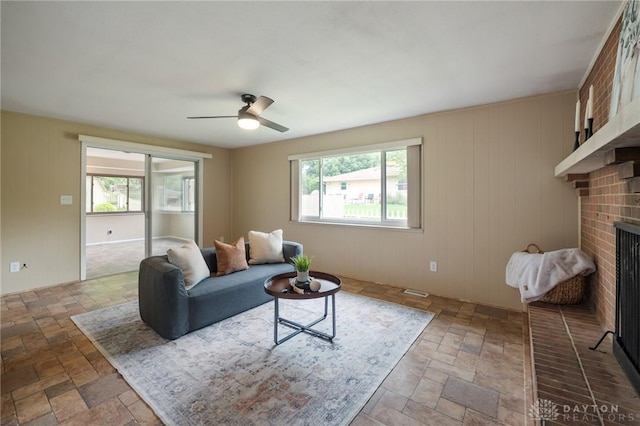521 Park Ridge Dr, Centerville, OH 45459 - living area with stone tile floors, a fireplace, and ceiling fan