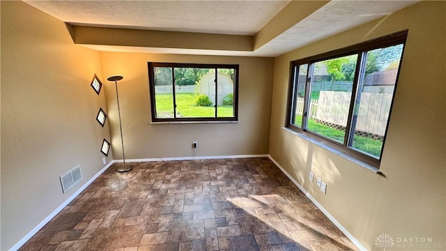 521 Park Ridge Dr, Centerville, OH 45459 - unfurnished room featuring stone tile flooring, healthy amount of natural light, and a textured ceiling