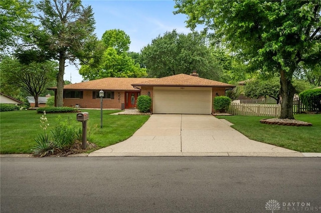521 Park Ridge Dr, Centerville, OH 45459 - single story home with an attached garage, concrete driveway, a chimney, and brick siding