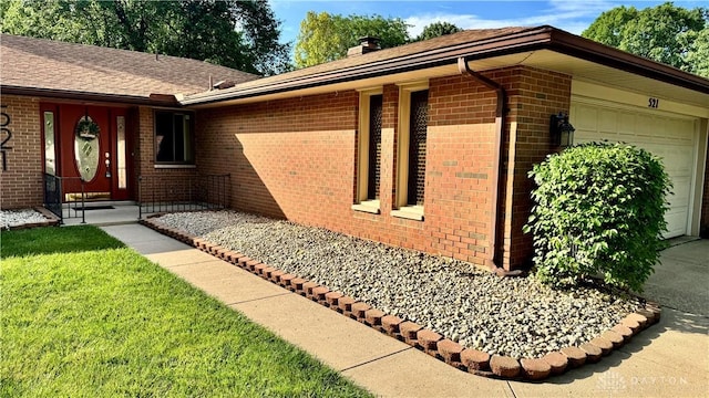 521 Park Ridge Dr, Centerville, OH 45459 - view of front of house with brick siding, an attached garage, a chimney, a front yard, and roof with shingles