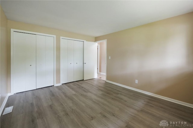 521 Park Ridge Dr, Centerville, OH 45459 - unfurnished bedroom featuring multiple closets and wood finished floors