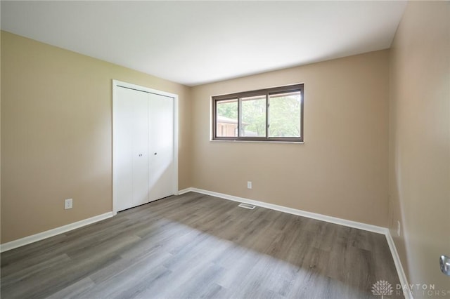 521 Park Ridge Dr, Centerville, OH 45459 - unfurnished bedroom featuring wood finished floors and a closet