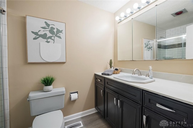 521 Park Ridge Dr, Centerville, OH 45459 - bathroom featuring vanity, tiled shower, and wood finished floors