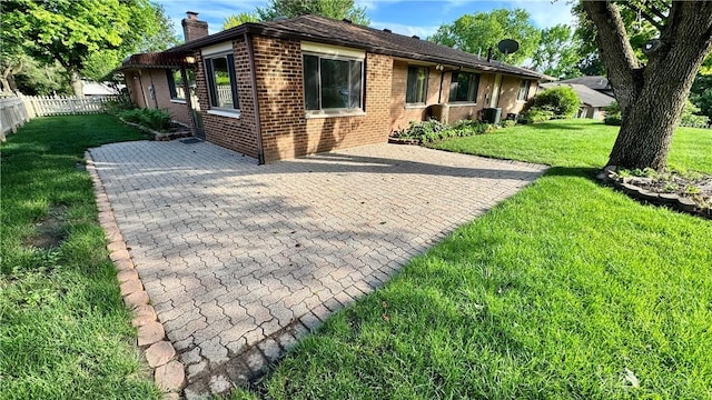 521 Park Ridge Dr, Centerville, OH 45459 - view of front of home featuring brick siding, a chimney, and a patio area