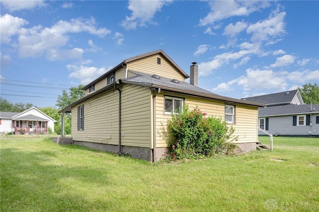 824 Euclid St, Bellefontaine, OH 43311 - view of side of home featuring a chimney and a lawn