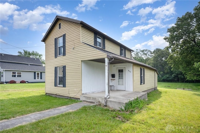824 Euclid St, Bellefontaine, OH 43311 - rear view of property featuring a lawn