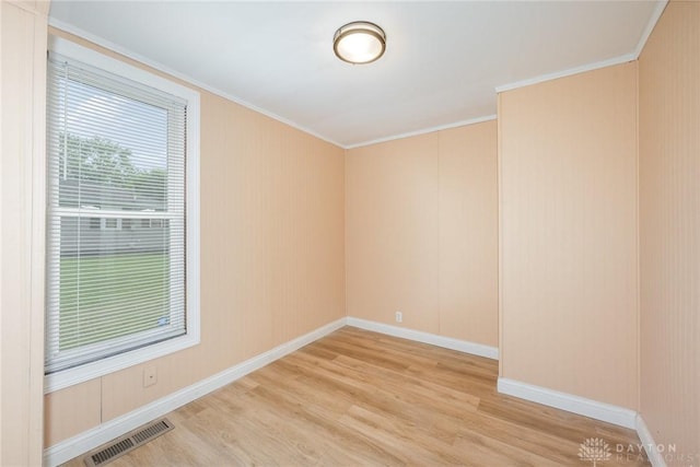 824 Euclid St, Bellefontaine, OH 43311 - spare room featuring light wood-style flooring and ornamental molding