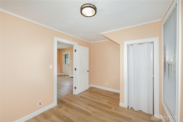 824 Euclid St, Bellefontaine, OH 43311 - unfurnished bedroom with crown molding, light wood finished floors, and a closet