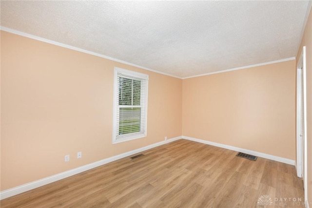 824 Euclid St, Bellefontaine, OH 43311 - empty room with light wood-style floors, a textured ceiling, and ornamental molding