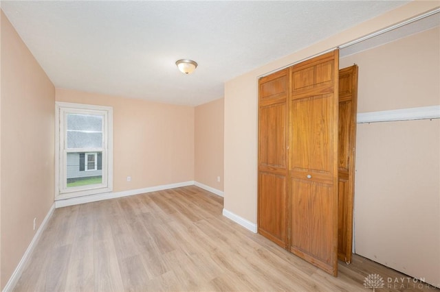 824 Euclid St, Bellefontaine, OH 43311 - unfurnished bedroom with light wood finished floors and a closet