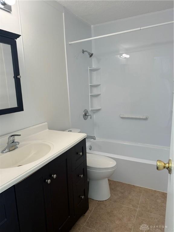 874 Bristol Dr, Vandalia, OH 45377 - bathroom with vanity, shower / tub combination, tile patterned floors, and a textured ceiling