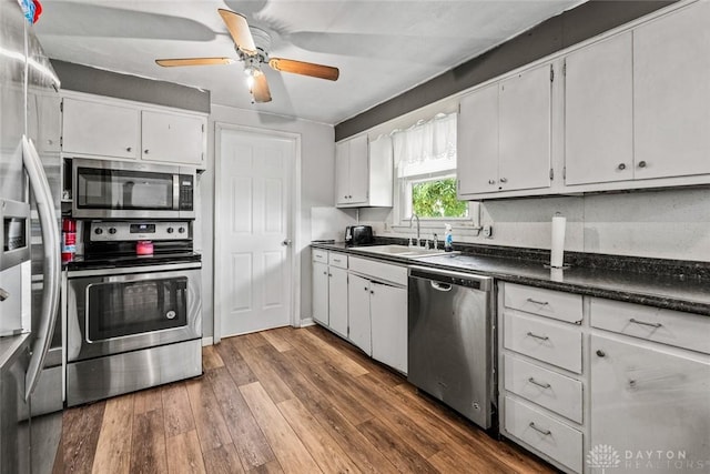 3878 State Route 49, Arcanum, OH 45304 - kitchen featuring appliances with stainless steel finishes, dark countertops, white cabinetry, and dark wood finished floors