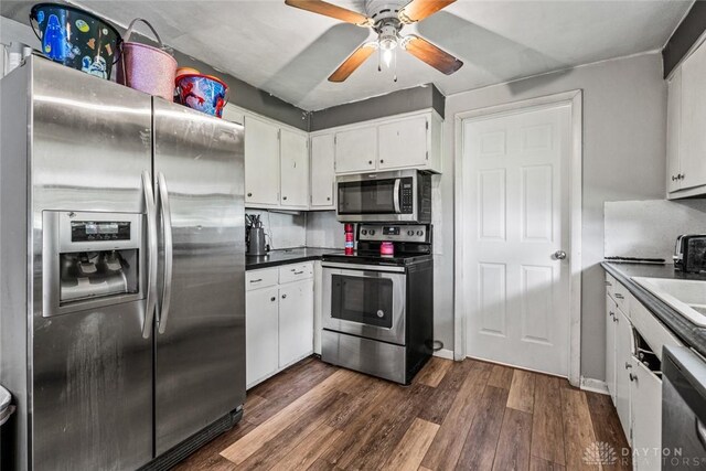 3878 State Route 49, Arcanum, OH 45304 - kitchen featuring appliances with stainless steel finishes, dark wood finished floors, ceiling fan, white cabinetry, and dark countertops