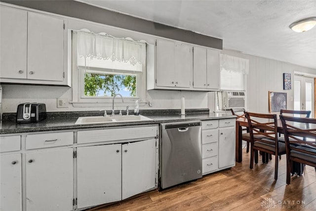3878 State Route 49, Arcanum, OH 45304 - kitchen featuring stainless steel dishwasher, dark countertops, white cabinetry, and light wood-style flooring
