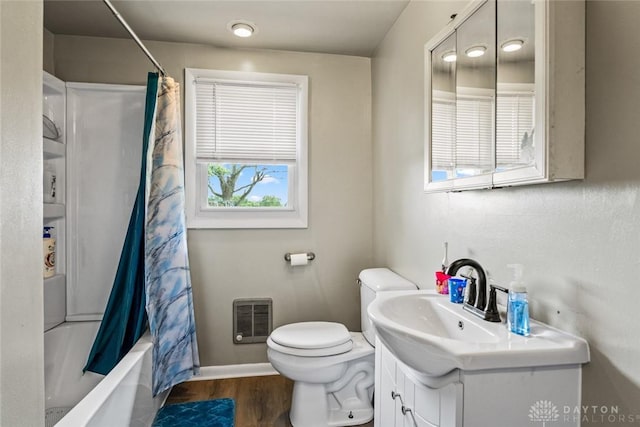 3878 State Route 49, Arcanum, OH 45304 - full bathroom with vanity, wood finished floors, shower / bathtub combination with curtain, and heating unit