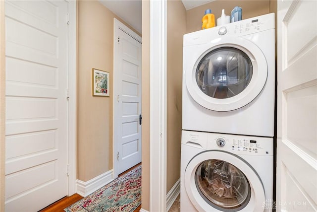 2356 Park Ave Unit 9, Cincinnati, OH 45206 - laundry area featuring stacked washer and clothes dryer and wood finished floors
