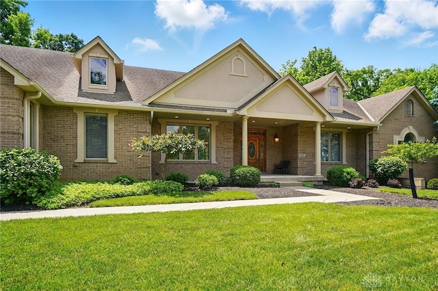 655 Devanshae Ct, Hamilton, OH 45013 - view of front of home with a porch, brick siding, a front lawn, and a shingled roof