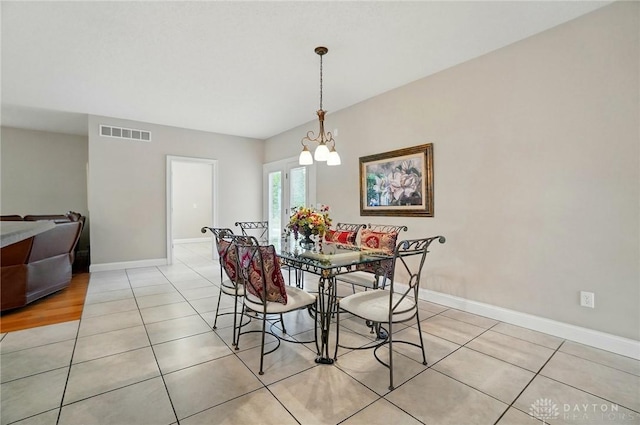 655 Devanshae Ct, Hamilton, OH 45013 - dining space with light tile patterned flooring and a chandelier