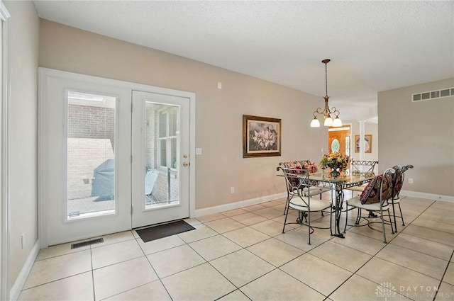 655 Devanshae Ct, Hamilton, OH 45013 - dining area featuring light tile patterned floors, a chandelier, and a textured ceiling