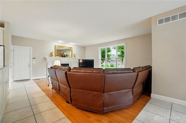 655 Devanshae Ct, Hamilton, OH 45013 - living area with light tile patterned flooring and a fireplace