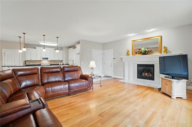 655 Devanshae Ct, Hamilton, OH 45013 - living room featuring light wood finished floors and a fireplace with flush hearth