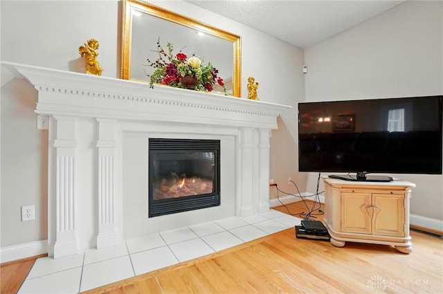 655 Devanshae Ct, Hamilton, OH 45013 - living area with light wood finished floors and a fireplace with flush hearth