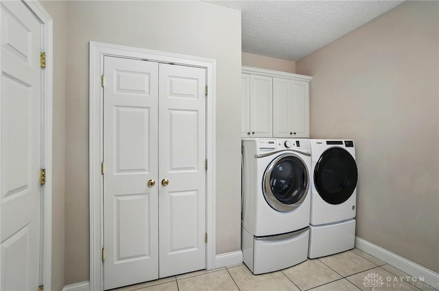 655 Devanshae Ct, Hamilton, OH 45013 - washroom featuring independent washer and dryer, light tile patterned flooring, cabinet space, and a textured ceiling