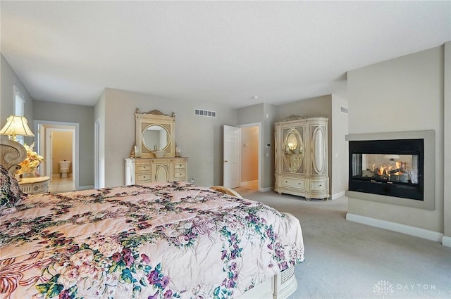 655 Devanshae Ct, Hamilton, OH 45013 - carpeted bedroom with a multi sided fireplace and ensuite bath