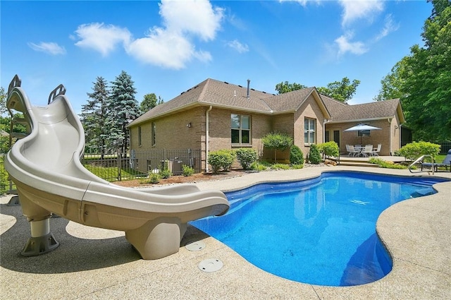 655 Devanshae Ct, Hamilton, OH 45013 - view of swimming pool featuring a water slide, a patio area, and outdoor dining space