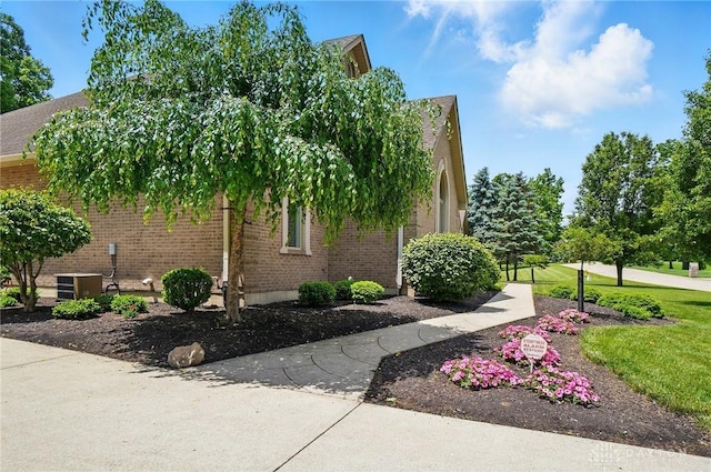 655 Devanshae Ct, Hamilton, OH 45013 - view of home's exterior with brick siding and a central air condition unit