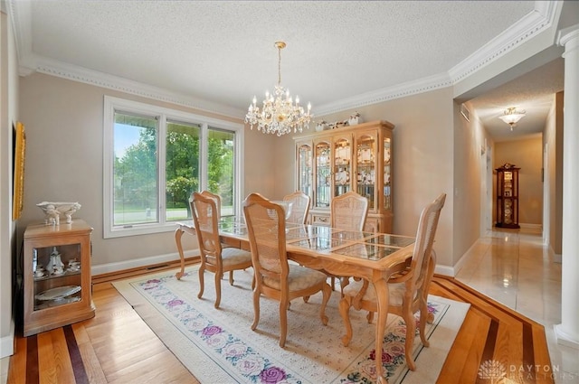 655 Devanshae Ct, Hamilton, OH 45013 - dining space with a chandelier, a textured ceiling, light wood-type flooring, and ornamental molding